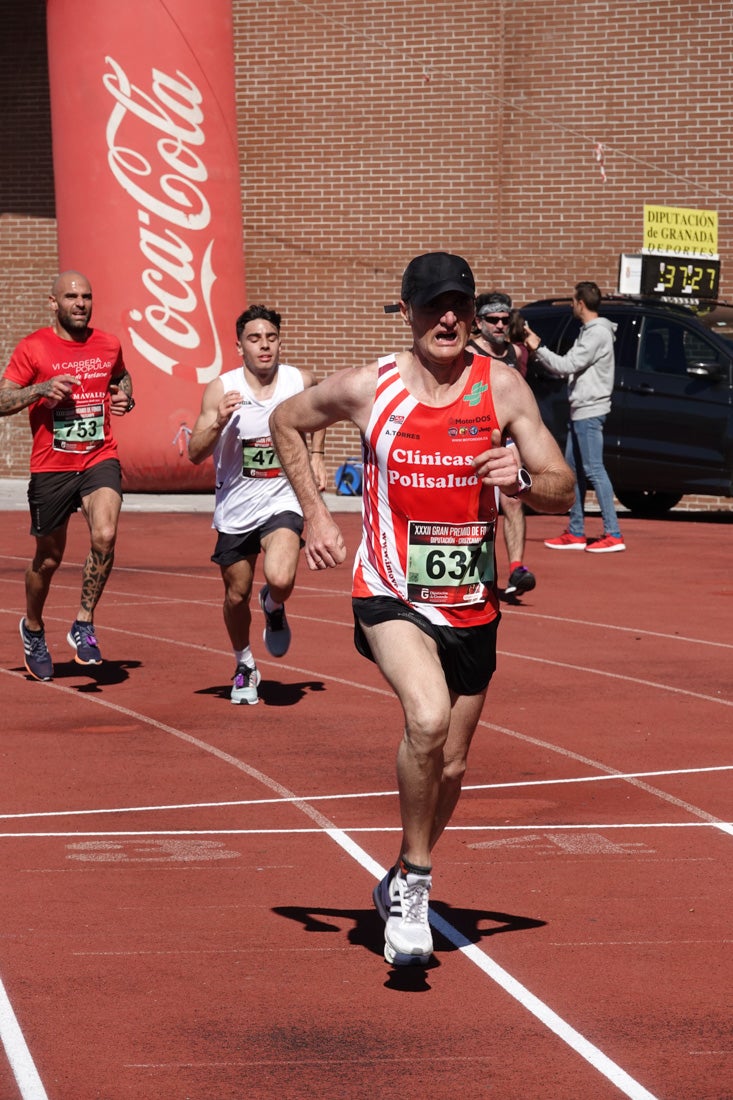 Manuel Santiago entra vistorioso a meta en la prueba de fondo de Loja. También lo hace victoriosa la más veterana de la cita. Y cientos de corredores desilan camino de la llegada al tartán.