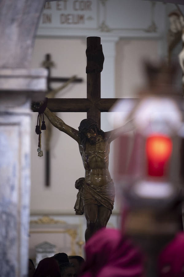 La imagen de Los Agustinos ha salido a la calle sobre las manos de los costaleros y rodeado de decenas de personas que le siguen con una vela encendida