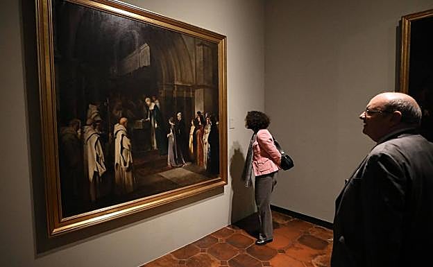 La rectora, Pilar Aranda, observando uno de los cuadros expuestos.