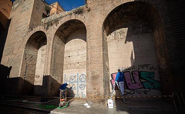 La limpieza se desarrolla bajo los tres arcos junto a la puerta principal.