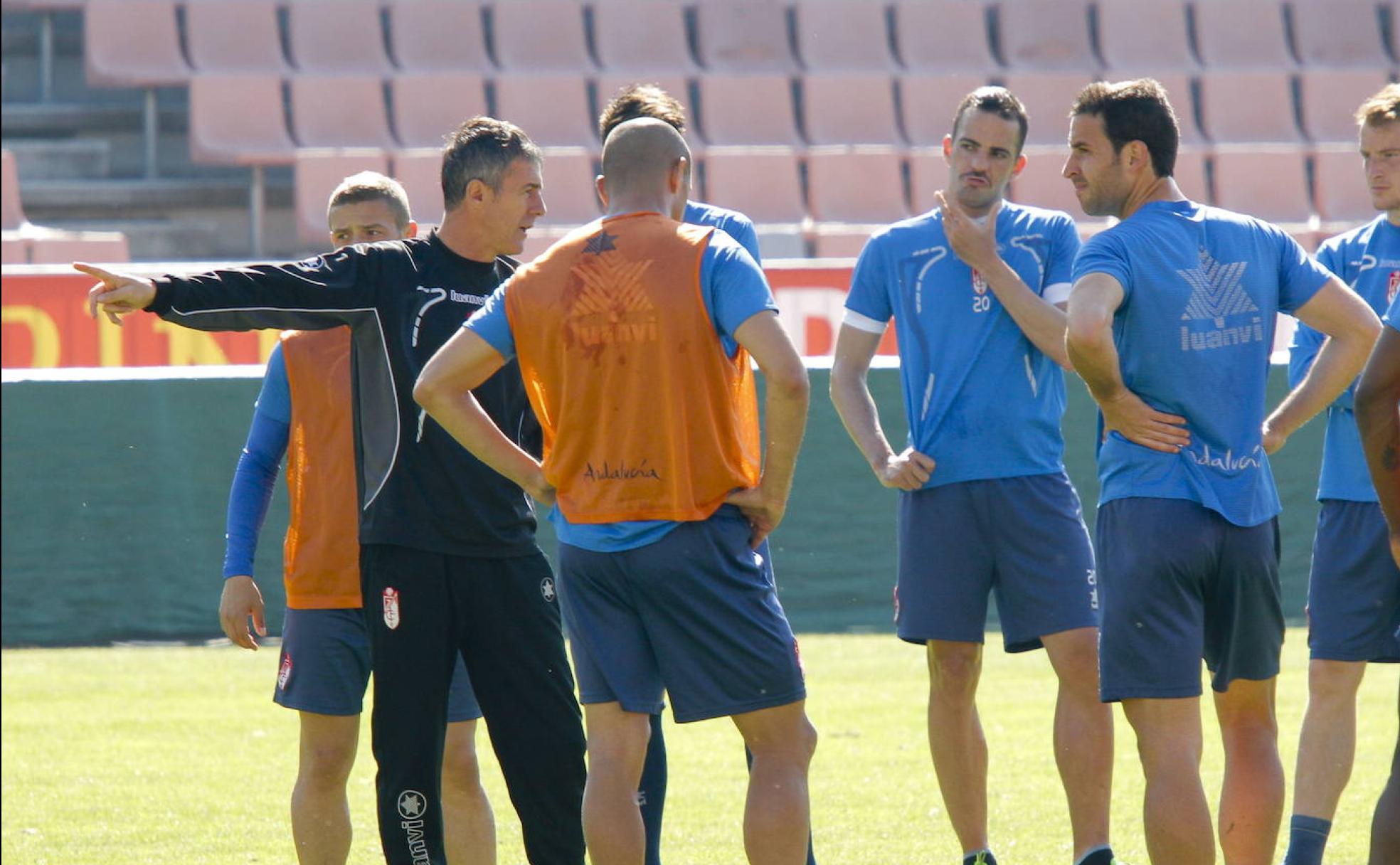 Lucas Alcaraz dirige una charla técnica durante un entrenamiento en Los Cármenes a la que atiende Íñigo López, luego jugador del PAOK.