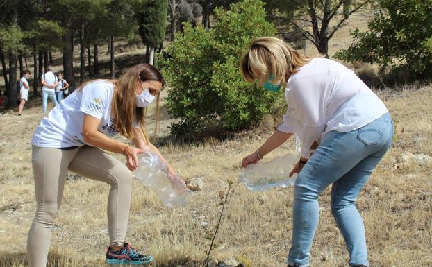 La delegada de la Junta y la concejala de Jaén, regando en la ladera del Cerro de Santa Catalina. 