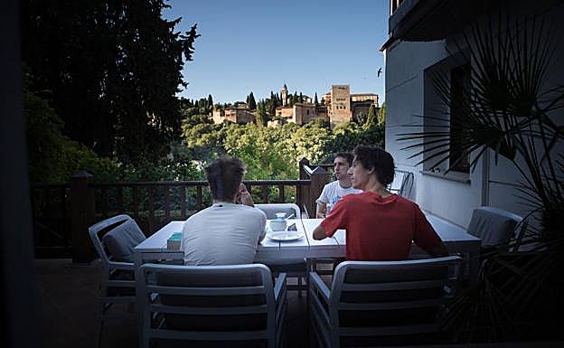 Un grupo de invitados belga desayuna con la Alhambra enfrente. 