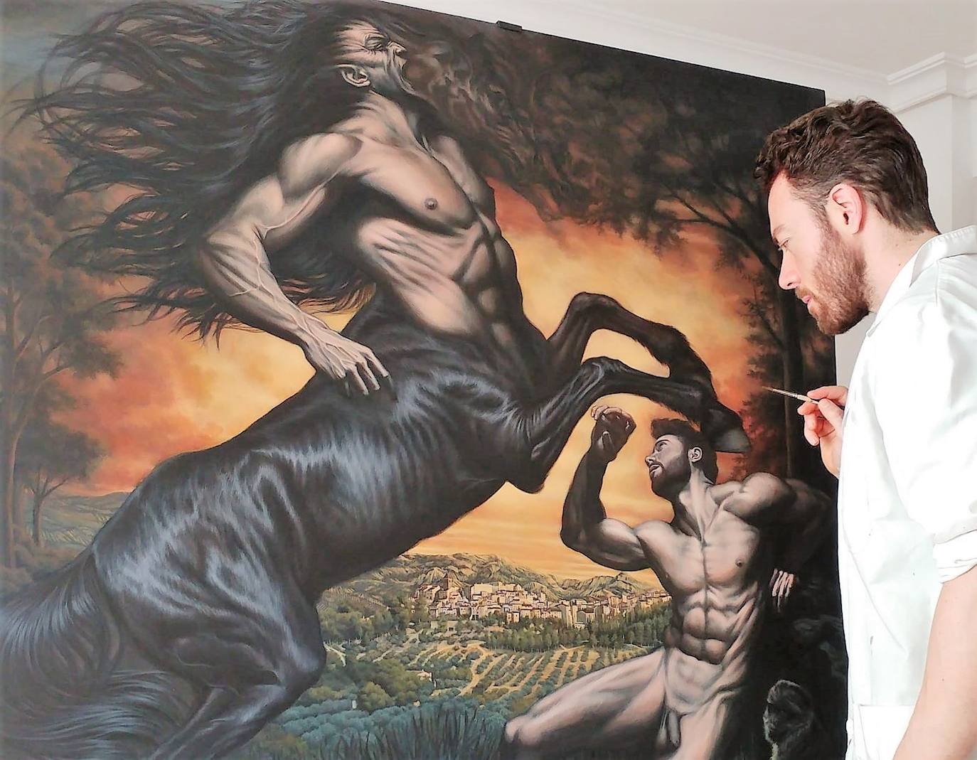 Alejandro Morata pinta uno de los cuadros de la muestra. 