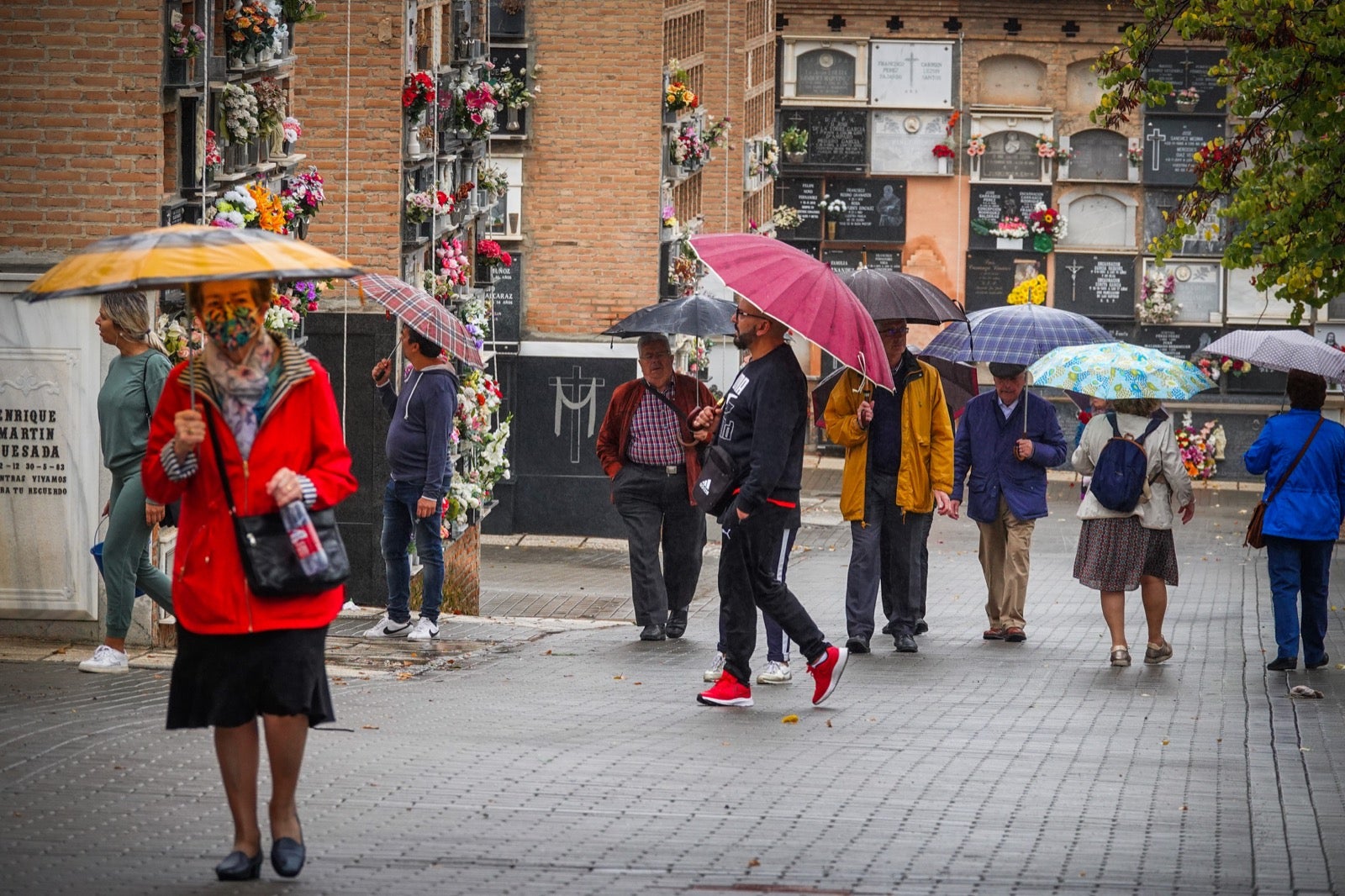 Los granadinos acuden al cementerio con flores en el día de Todos los Santos.