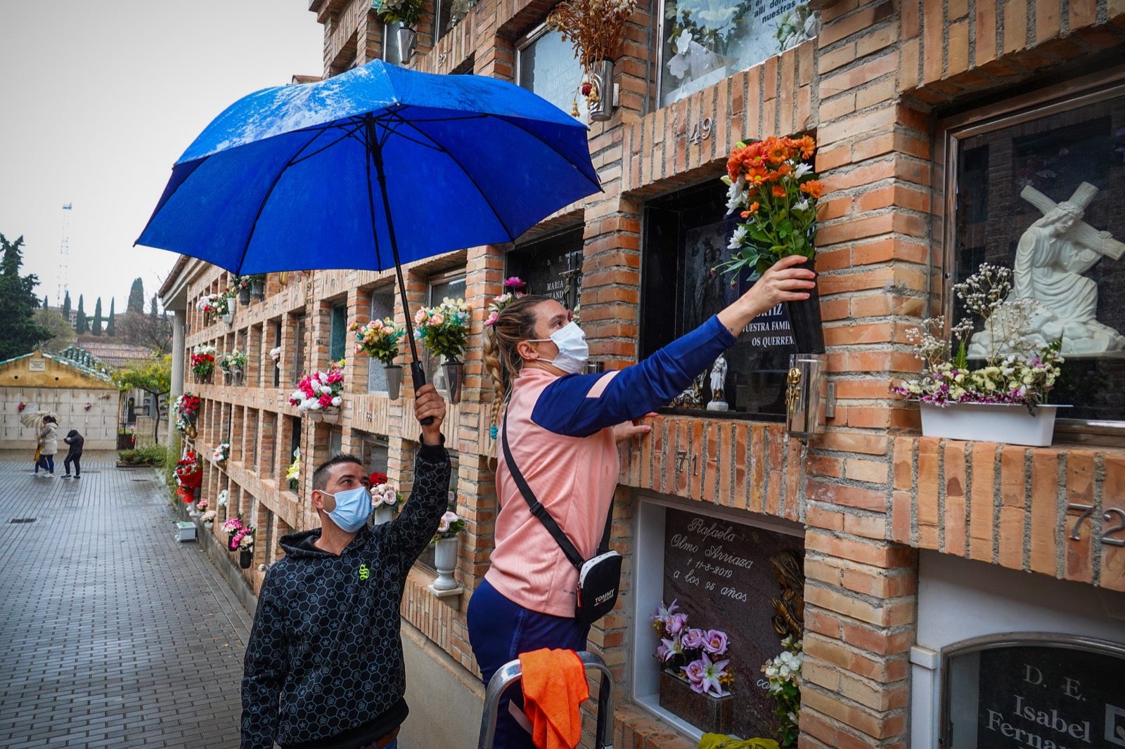 Los granadinos acuden al cementerio con flores en el día de Todos los Santos.