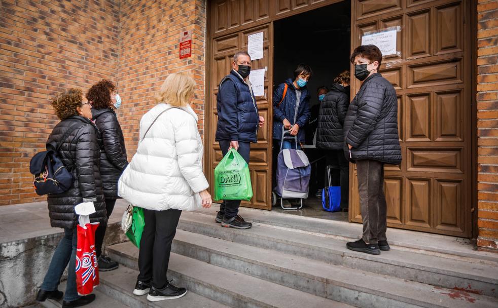 Granadinos esperan a la entrada del salón parroquial del Santo Custodio para entregar medicinas y alimentos.