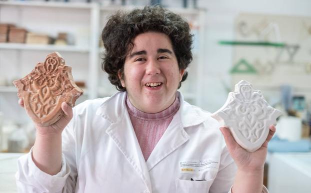 Ana muestra con orgullo dos de las piezas de cerámica que ha hecho en el taller. 