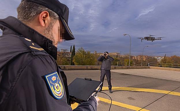 Dos agentes controlan el vuelo de un dron
