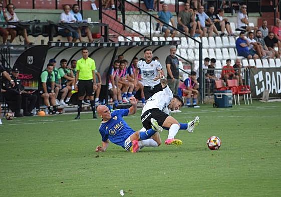 Javi Rentero intentando frenar a un jugador emeritense en la primera jornada de liga.