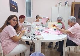 Socias de Ajicam haciendo cojines en forma de corazón para aliviar el dolor de la cirugía mamaria, en una imagen de archivo.