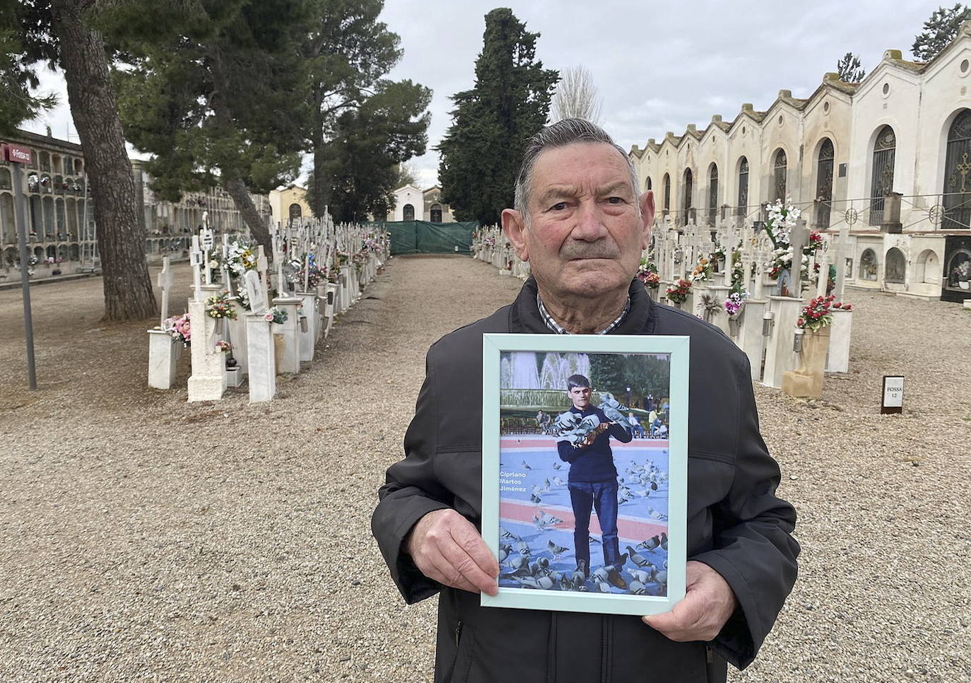 Antonio Martos sostiene una foto de su hermano Cipriano, en el cementerio de Reus. 