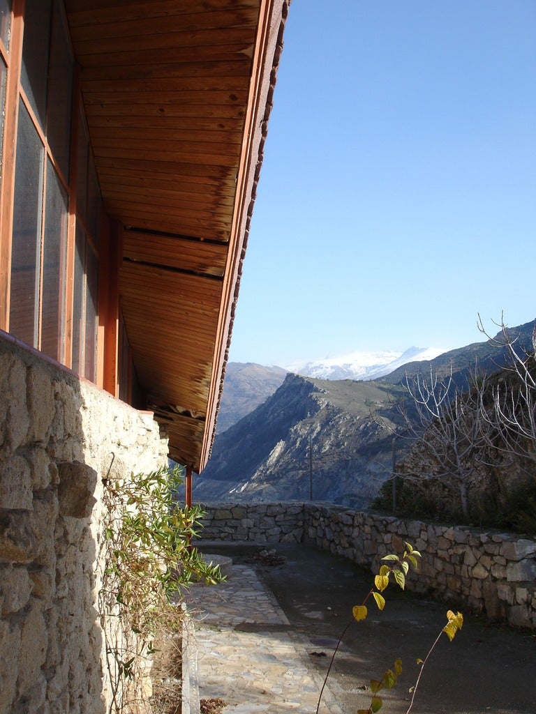 Imagen secundaria 2 - Vistas del interior del altar desde un lateral, del pórtico la fachada y de una zona exterior desde donde se puede ver Sierra Nevada.