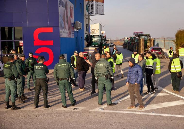 Agentes de la Guardia Civil hablan con los agricultores concentrados en Santa Fe