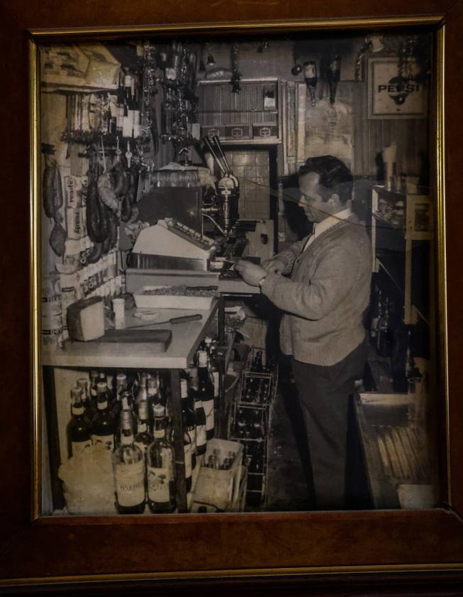 Imagen secundaria 2 - Alfonso, en su mítico rincón del bar donde ha atendido a miles de granadinos durante todos estos años. Junto al pequeño columpio para los peques en el que se han subido varias generaciones. Su padre, Antonio.