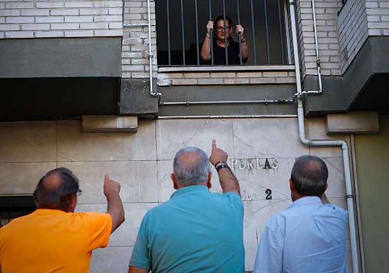 Vecinos de la Chana reunidos en la calle, justo debajo de una de las ventanas que ha sido sustraídas.