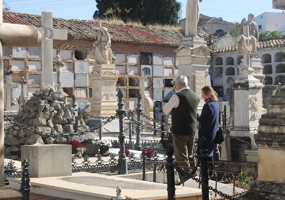 Pareja observa una tumba en el cementerio de San Eufrasio