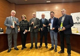 Autoridades y miembros del jurado posan con los aceites ganadores.