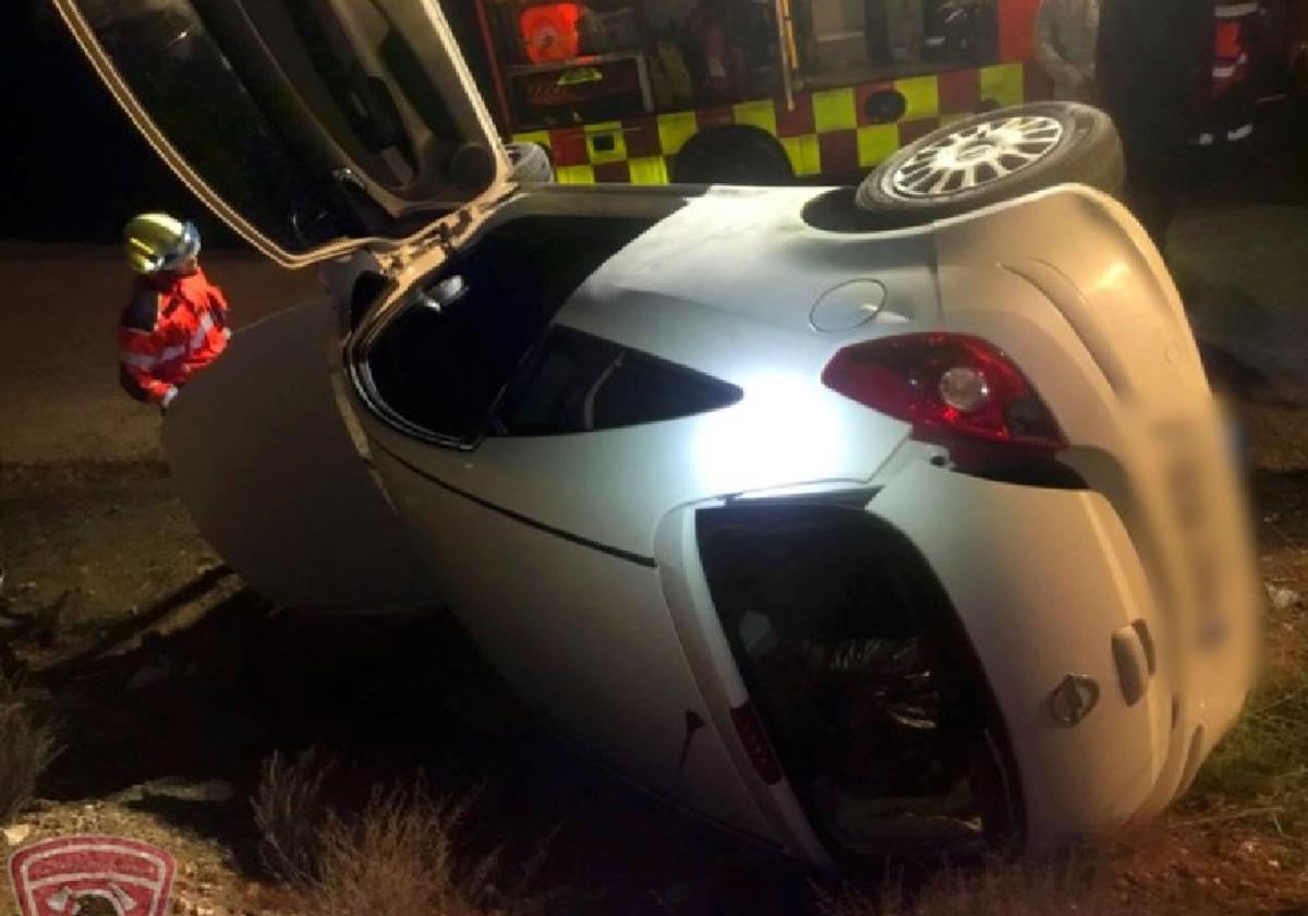 El coche quedó volcado de costado tras salirse de la carretera.