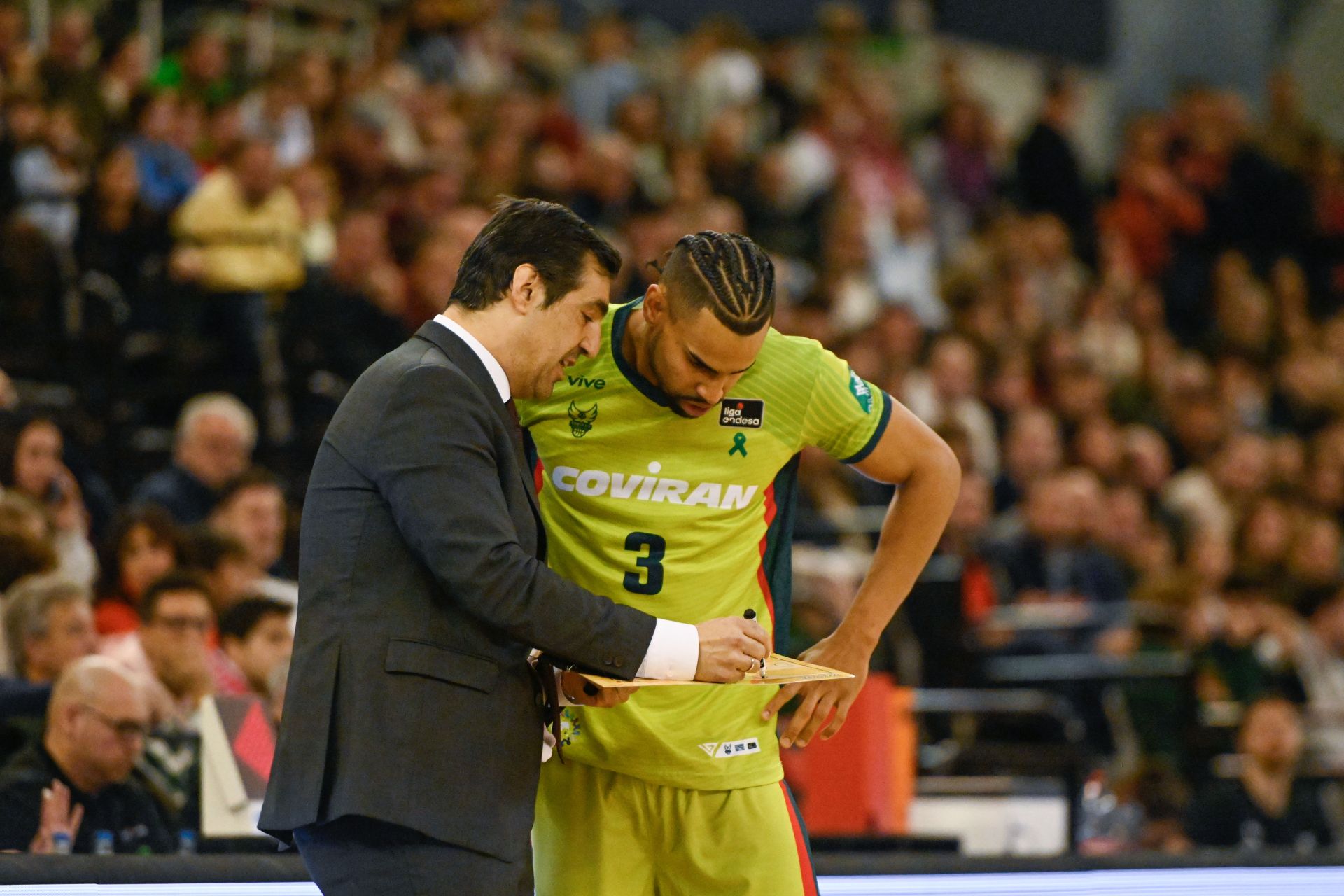 Gian Clavell atiende con mucho interés las indicaciones de Pablo Pin sobre la pizarra en el partido contra el Girona en el Palacio de los Deportes.