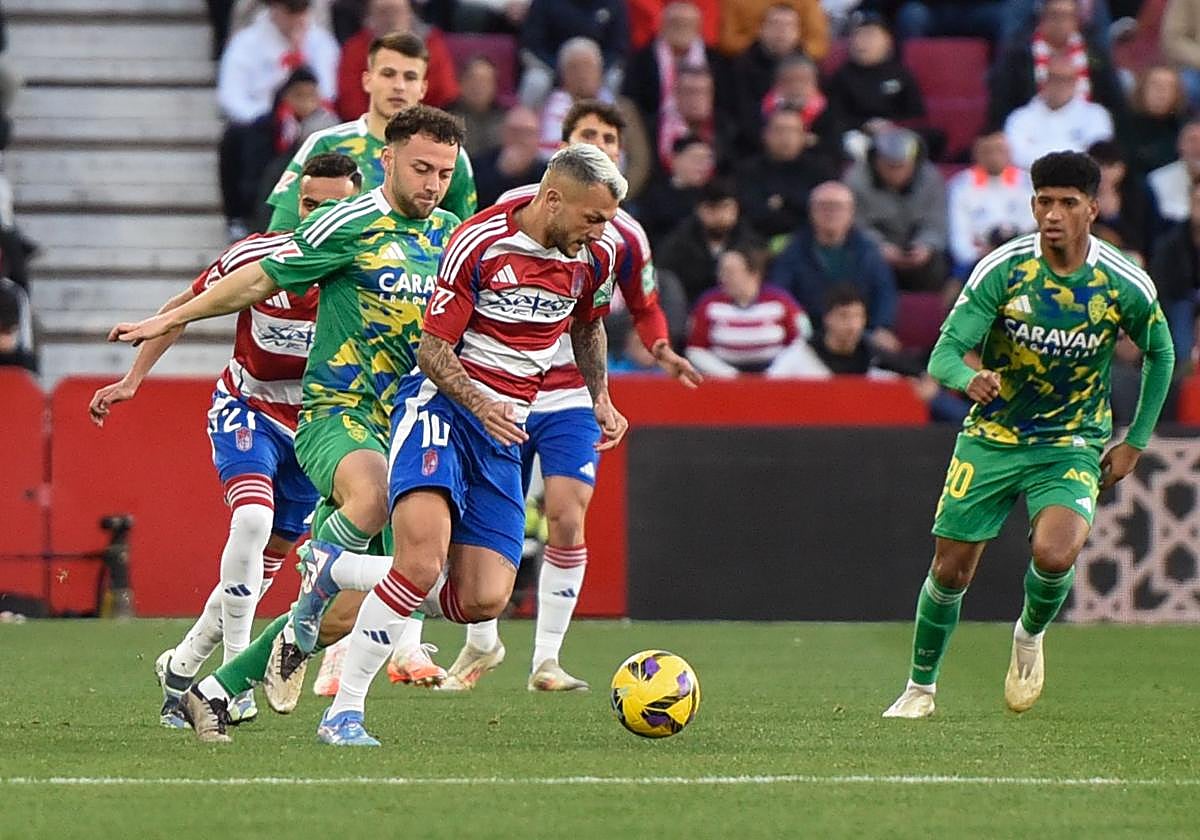 Stoichkov intenta avanzar entre varios rivales durante el partido con el Real Zaragoza.