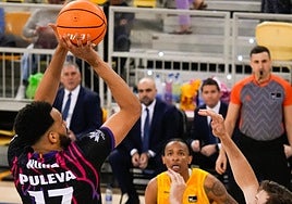 Momento del partido del Covirán en el Gran Canaria Arena, aquí Noua lanza ante la mirada de Thomasson.
