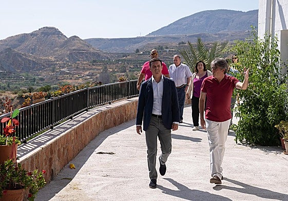 El alcalde de Bentarique, Modesto Martínez, enseña una de las calles de este municipio de la Alpujarra al presidente de la Diputación.