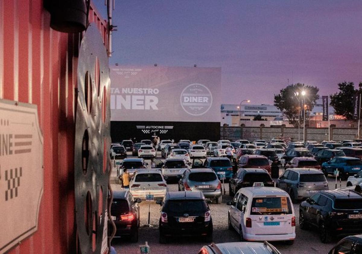 Imagen principal - Coches repartidos por la superficie del Autocine Madrid, antes de que se inicie la proyección. 