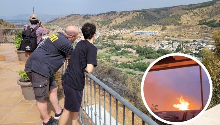 Decenas de curiosos se acercan para observar el panorama desolador de toda la vegetación de la ladera completamente chamuscada (en pequeño, las llamas cerca del restaurante Balcón del Genil).