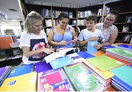 Una familia se prepara para la vuelta al cole en cuna librería.
