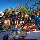 El subdelegado del Gobierno y la alcaldesa de Granada observan uno de los talleres con niños.