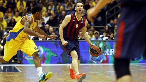 Huertas (c) avanza con el balón junto a Alex Tyus (i). 