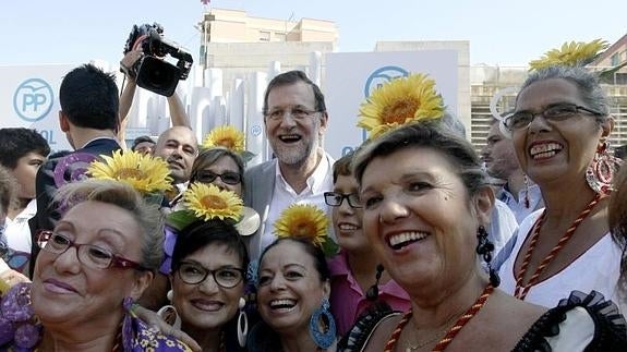 Rajoy se fotografía con varias simpatizantes a su llegada al mitin.