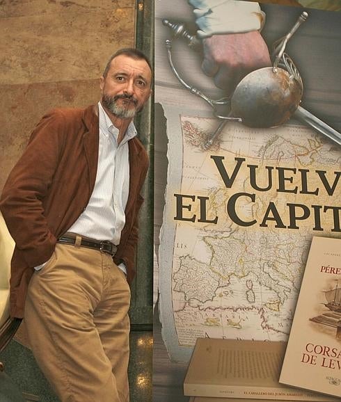 Pérez-Reverte, con la portada de uno de sus libros.