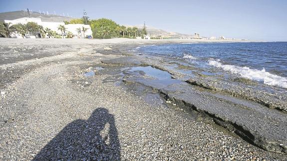En muchas zonas de la playa de Carchuna la arena ha desaparecido y ha dejado al descubierto inmensas planchas de rocas que impiden el baño. 