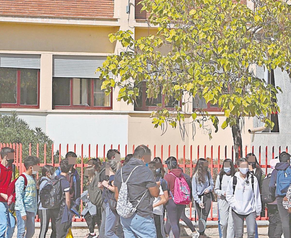 Varios grupos de alumnos en el exterior del recinto de un instituto de la ciudad.