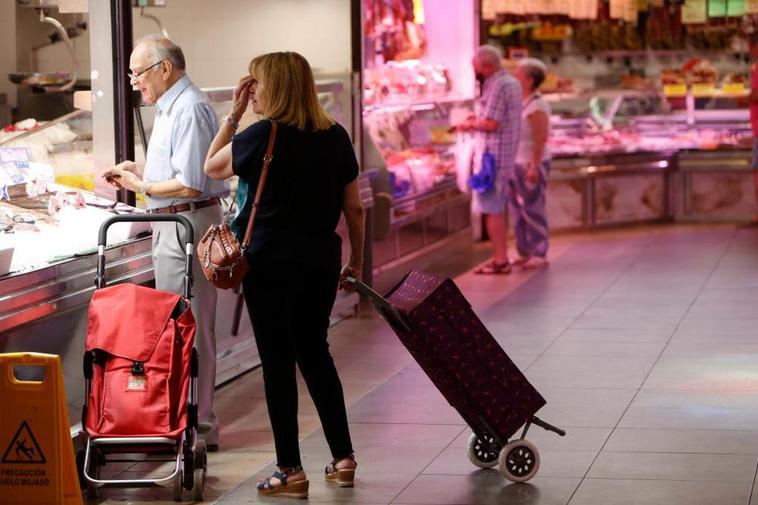 Clientes en varios puestos del Mercado Central de Salamanca para hacer su compra semanal.