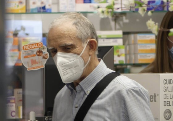 Una persona accede a una farmacia salmantina con una mascarilla.