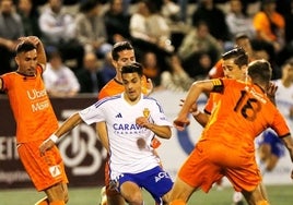 Un jugador del Zaragoza trata de regatear a cuatro del Atzeneta en el choque que ha cerrado la primera ronda de la Copa.