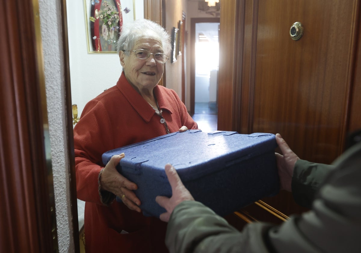 Una usuaria salmantina recibe su comida a domicilio.