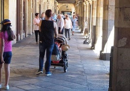 Una madre joven de Salamanca pasea con su carrito por la Plaza Mayor.