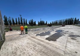 Varios operarios y máquinas durante la primera jornada de trabajo en el campo de fútbol.