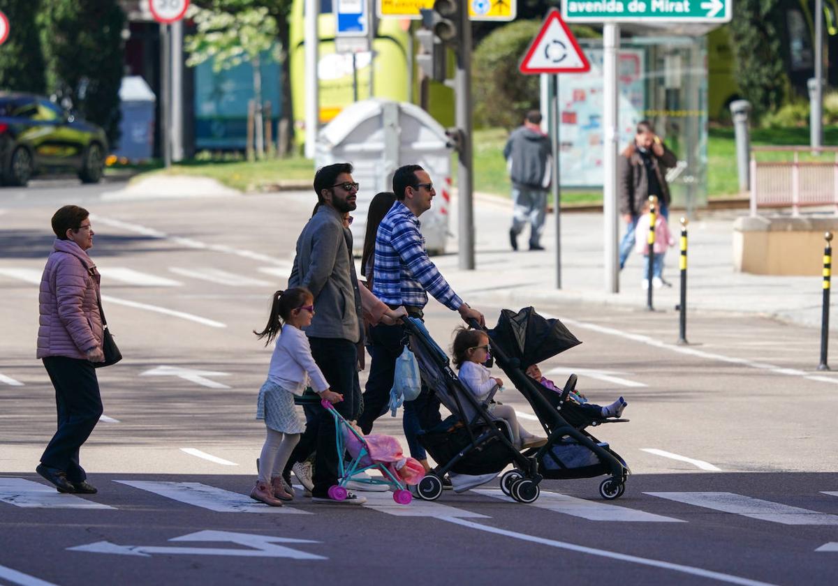 Imagen de una familia paseando por Salamanca con un carrito de bebé.