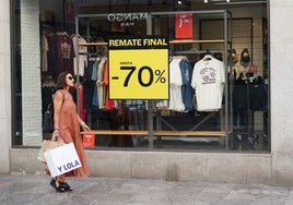 Una compradora con bolsas pasea por la calle Toro.