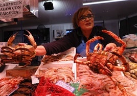 Una pescadera muestra algunos de los productos más cotizados en las Navidades.