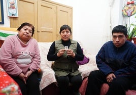 Milagros, en el centro con la fotografía de su hijo en las manos, junto a dos allegados en su casa de Salamanca.