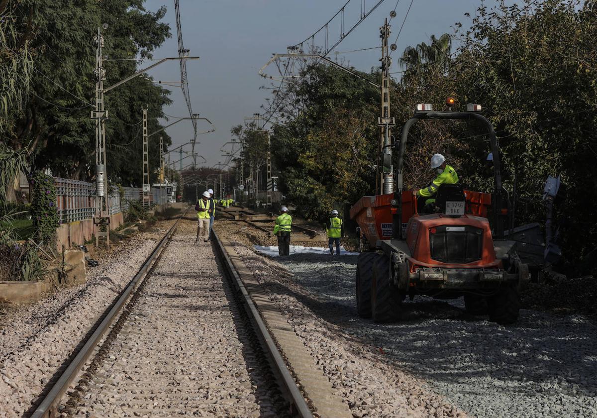 Varios operarios de Adif trabajan en unas vías de tren.