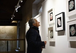 Una mujer observando las piezas de la exposición.