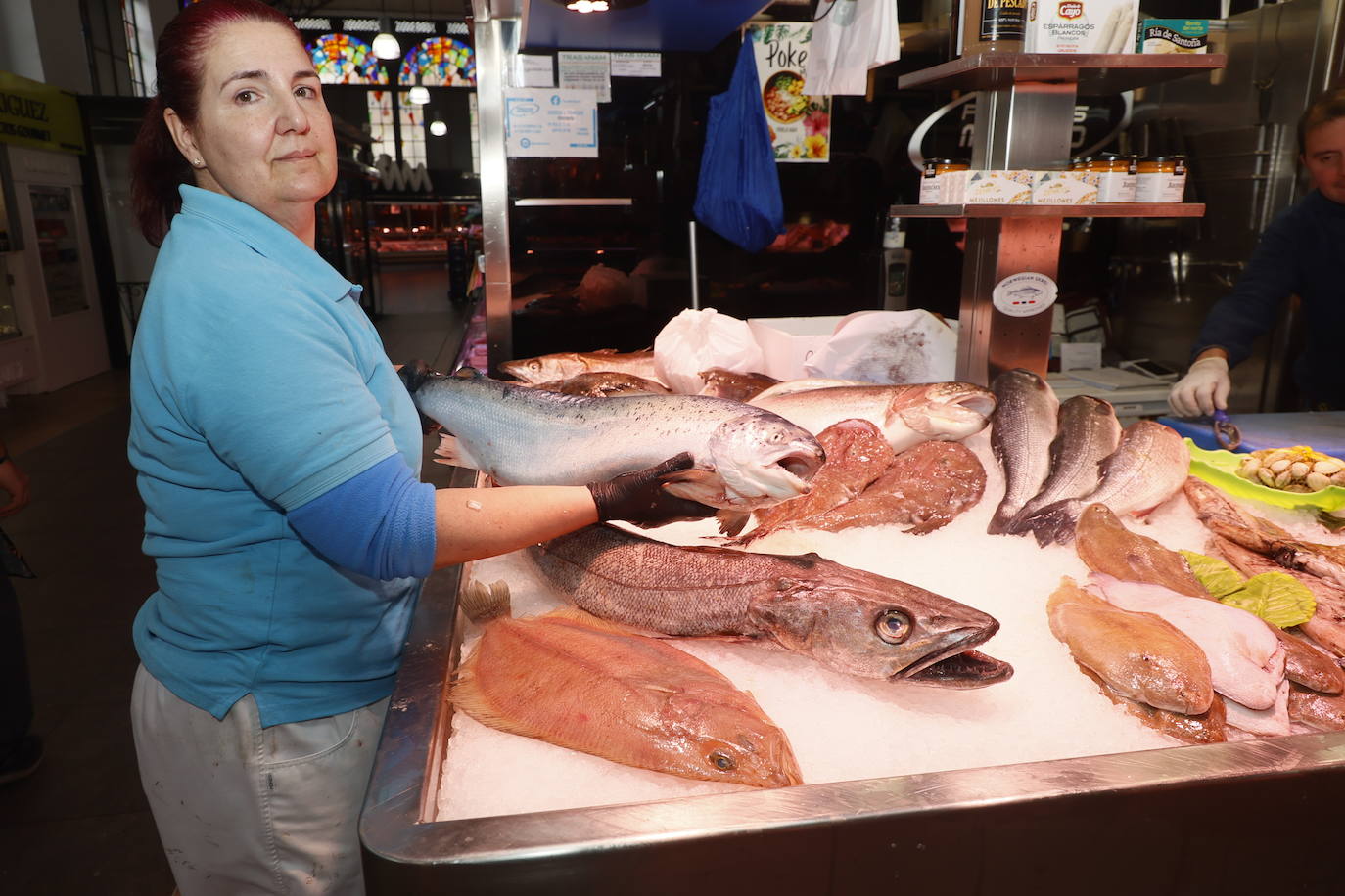 Una pescadera del Mercado Central sostiene uno de los productos que más han subido de precio en los últimos días.
