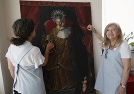 Carmen Diego y Carmina Fernández restaurando el lienzo de la Virgen de los Desamparados.